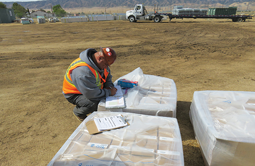 Photo 8. Special inspector is performing sampling of automotive Huck fasteners used in place of high strength connections. These fasteners require testing/verification to the appropriate ASTM Standard, which in this case was ASTM-325. 