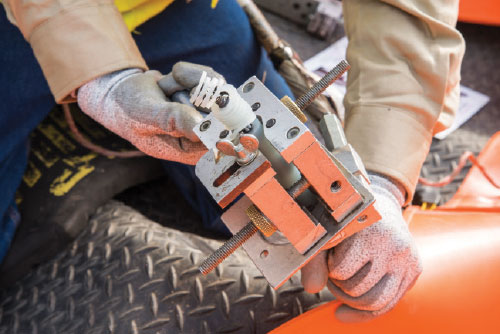 Photo 1. A portion of the electrical cable insulation is removed to attach an injection adapter in preparation for injection of Cablecure rejuvenation fluid.