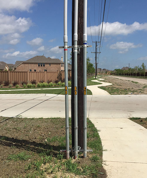 Photo 2. Rigid metal conduit risers attached to utility pole.