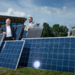 Dr. Stuart Baur (left) and Thomas Yarbrough with discarded solar panels at Missouri S&T's EcoVillage. Photo by Tom Wagner, Missouri S&T.