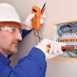 Electrician using proper ppe per NFPA 70E, ensuring safe work practices