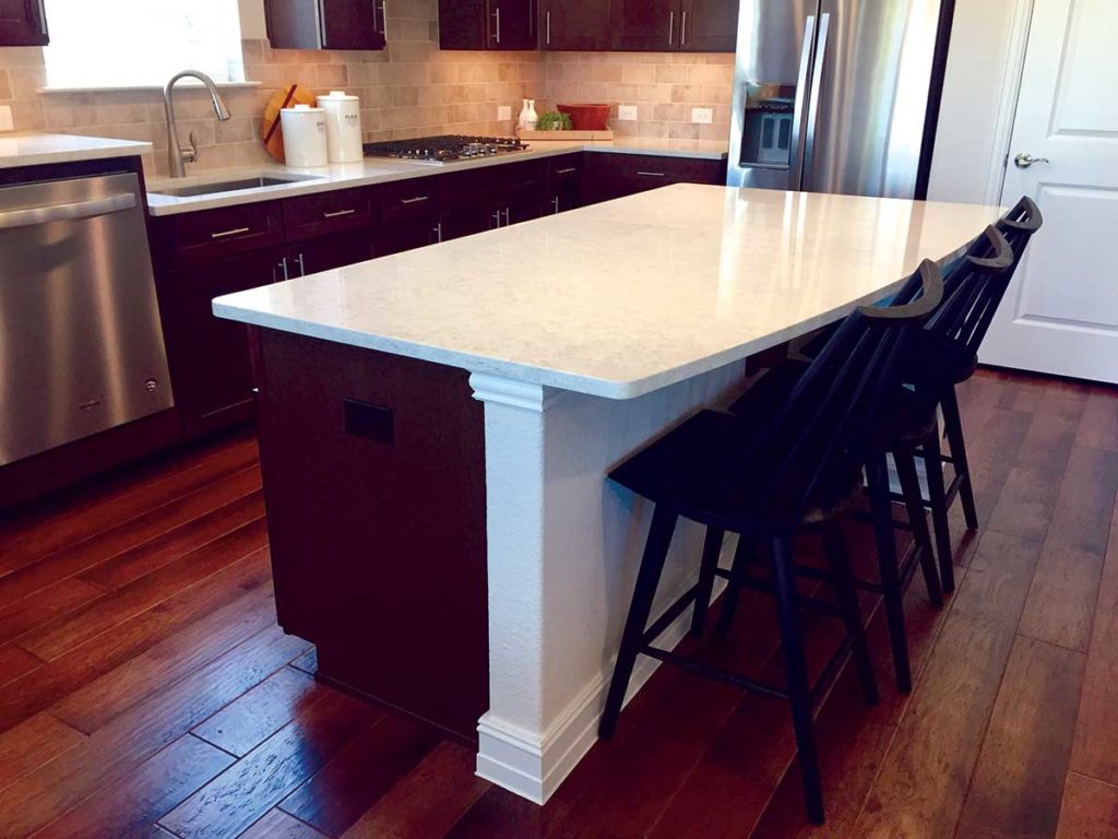 Photo 3. Rectangular kitchen island with a curved edge and seating.