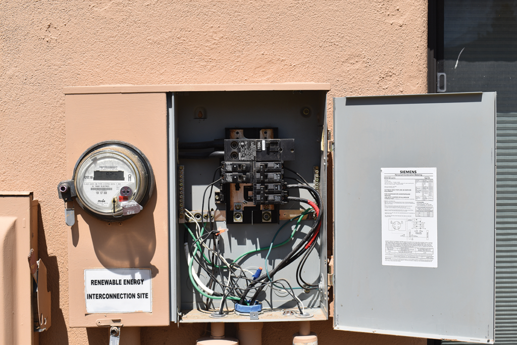 Photo 1. Meter-main combination service entrance panel. Four 2-pole breaker positions are available for loads as are main lugs for feed through. The utility has locked the metering section. Photo by John Wiles.